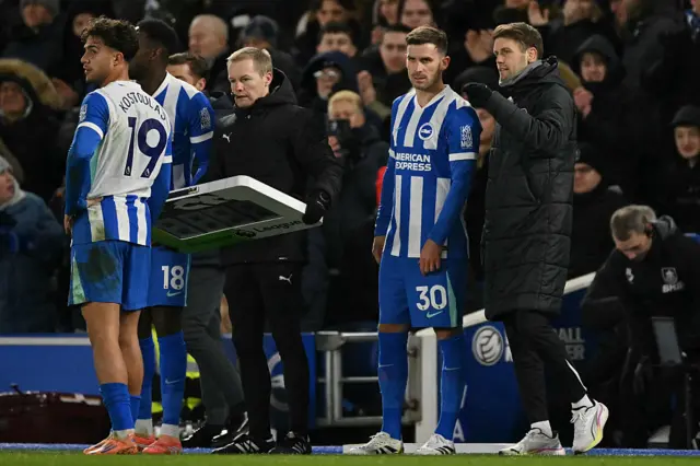 Brighton's German midfielder #30 Pascal Gross (2R) gets his instructions