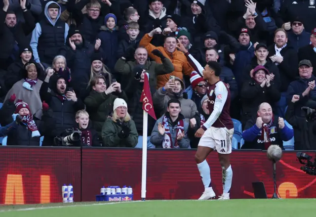 Aston Villa's English striker #11 Ollie Watkins (2L) shoots to score the opening goal