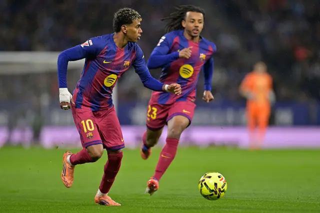 Barcelona's Lamine Yamal runs with the ball during the Spanish League football match between RCD Espanyol and FC Barcelona at RCDE Stadium in Cornella de Llobregat on January 3, 2026