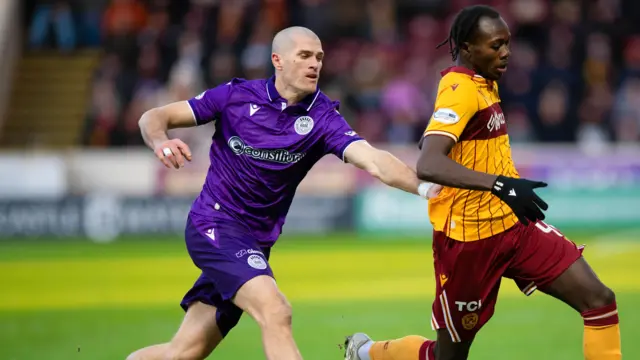Motherwell's Emmanuel Longelo and St Mirren's Alex Gogic in action during a William Hill Premiership match between Motherwell and St Mirren at Fir Park