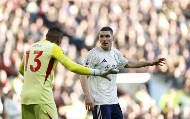 Nottingham Forest goalkeeper John Victor (left) speaks with team mate Nikola Milenkovic