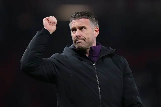 Rob Edwards, head coach of Wolverhampton Wanderers, acknowledges the traveling support after the Premier League match between Manchester United and Wolverhampton Wanderers at Old Trafford on December 30, 2025 in Manchester, England.