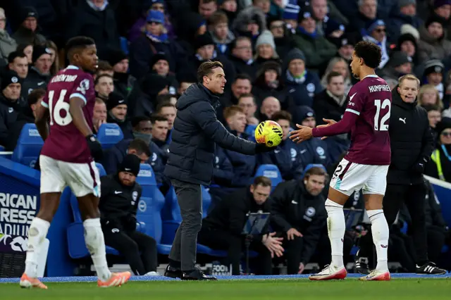 Scott Parker, Manager of Burnley, hands the ball to Bashir Humphreys of Burnley