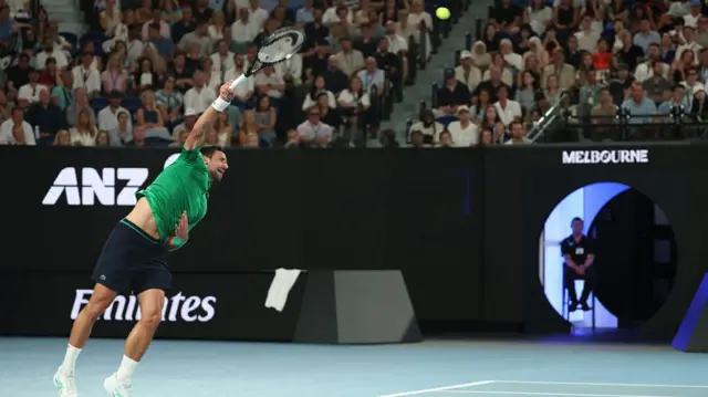 Novak Djokovic serves