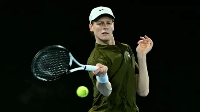 Jannik Sinner hits a forehand
