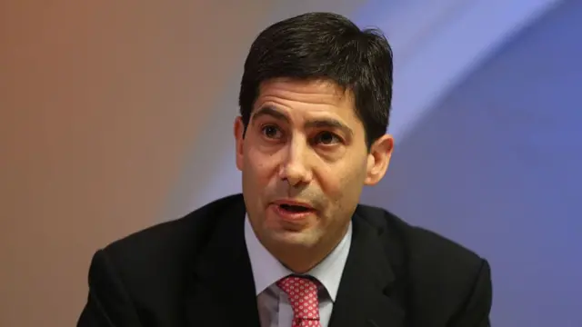 Kevin Warsh, a white man with dark hair wearing a suit.
