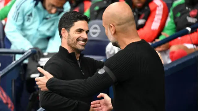 Mikel Arteta and Pep Guardiola hug and shake hands