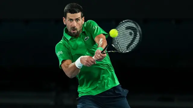 Novak Djokovic hits a backhand