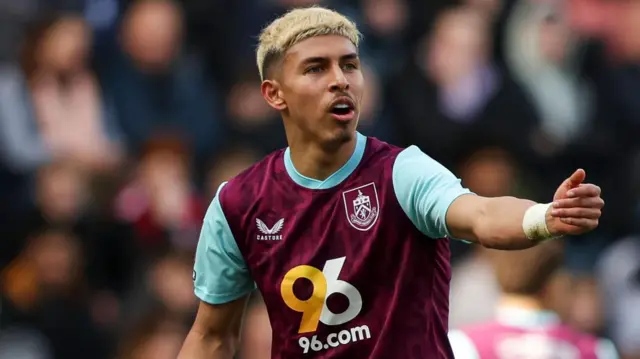 Jeremy Sarmiento playing for Burnley last season, making a gesture to another player with his left arm outstretched