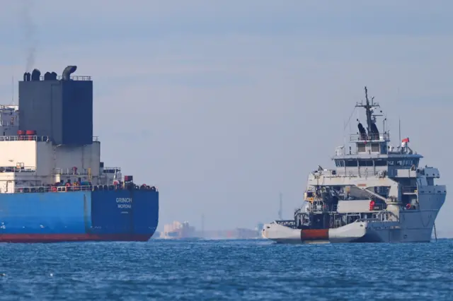 A tanker (left) named Grinch in the Mediterranean Sea next to a French navy vessel (right)