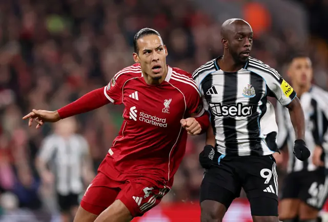 Van Dijk and Wissa shoulder barge one another