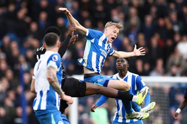 Brighton and Everton players duel for a ball in the air