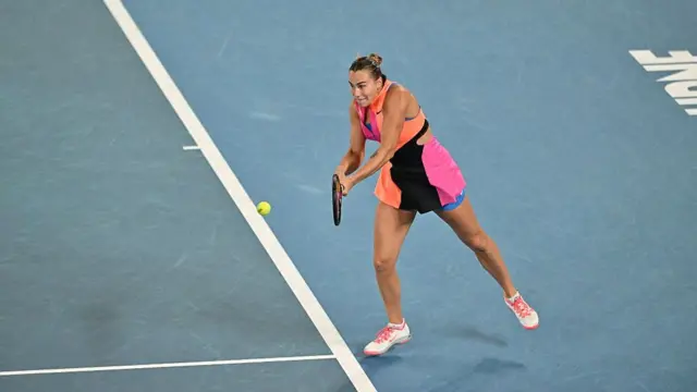 Aryna Sabalenka hits a backhand
