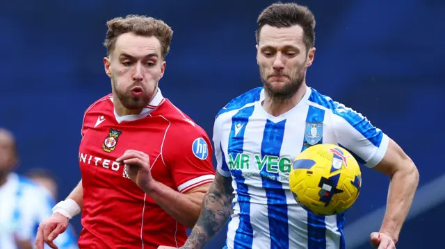 Liam Cooper of Sheffield Wednesday battles with Sam Smith of Wrexham