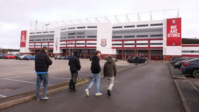 Fans make their way across the car park outside the Bet365 Stadium