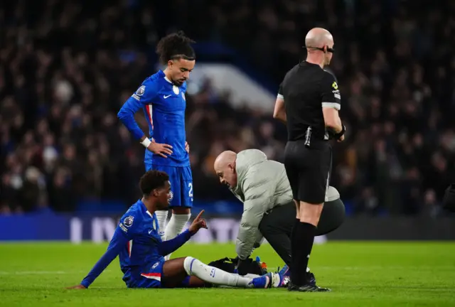 Jamie Gittens on the floor receiving treatment