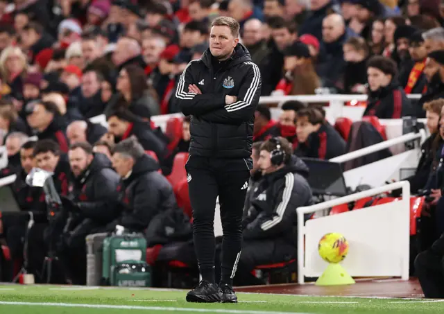 Eddie Howe stands with arms crossed on the touchline