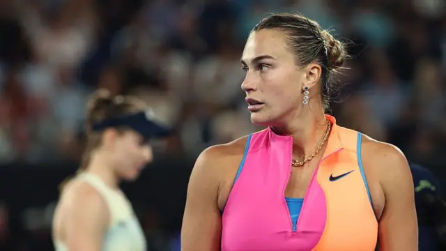 Aryna Sabalenka looks at her coaching box