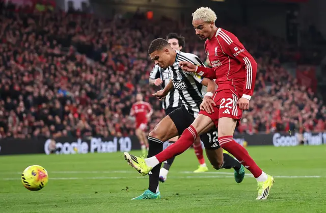 Ekitike flicks in the second goal with the outside of hit foot as a Newcastle defender tries in vain to tackle him