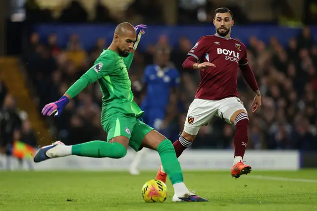 Robert Sanchez of Chelsea clears away from Taty Castellanos of West Ham United during the Premier League match