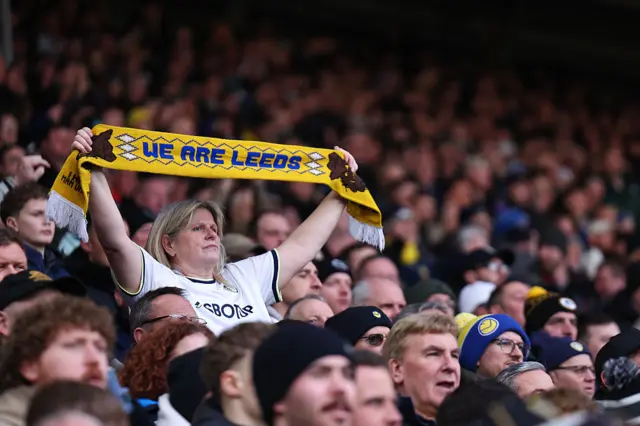 Leeds fan holds up a scarf