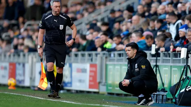West Brom's Eric Ramsay crouches on the touchline at Fratton Park