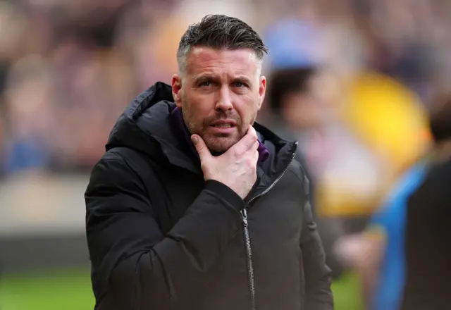 Edwards strokes his chin deep in thought