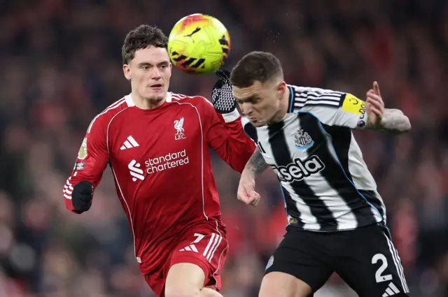 Trippier heads clear before Wirtz can reach the ball