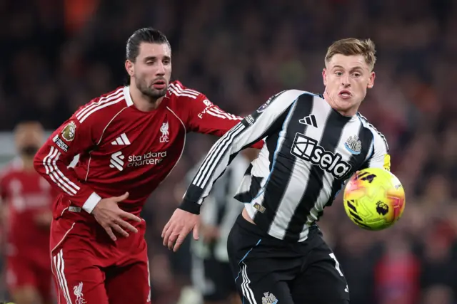 Harvey Barnes of Newcastle United (R) in action against Dominik Szoboszlai of Liverpool