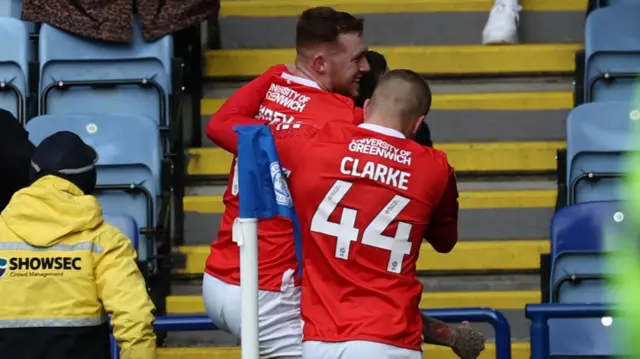 Charlton players celebrate by the corner flag