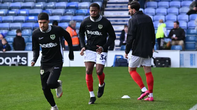 Portsmouth players warm up at Fratton Park