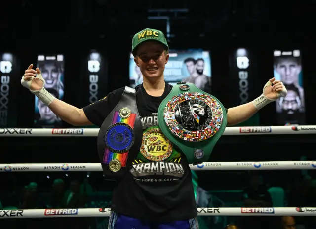 Fran Hennessy with belts around her shoulders