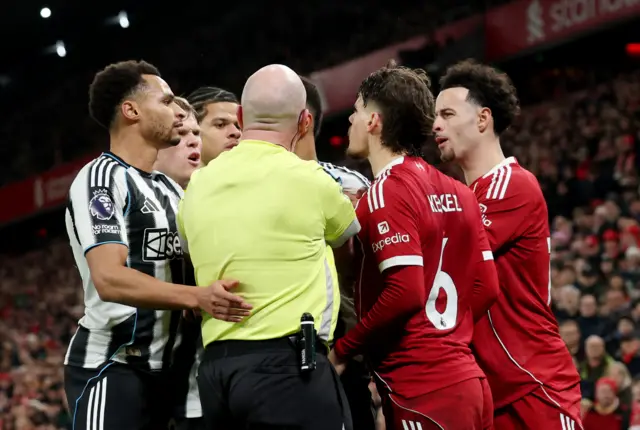 Newcastle and Liverpool players fight after a late challenge