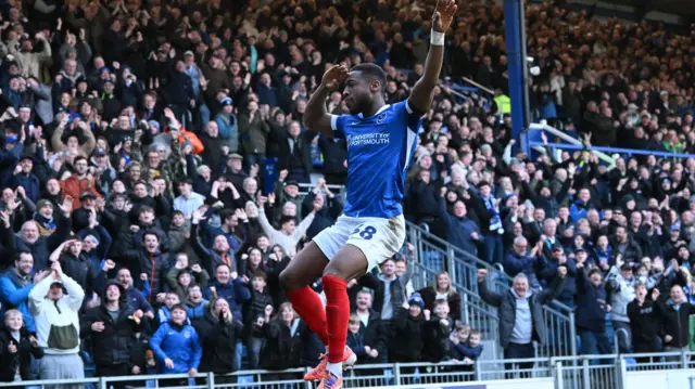 Ebou Adams jumps into the air to celebrate