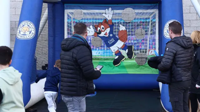 Young fans take part in a penalty competition with an inflatable goal outside Leicester's King Power Stadium