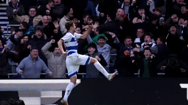 Nicolas Madsen celebrates in front of the QPR fans