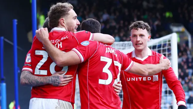 Wrexham players celebrate with Sam Smith