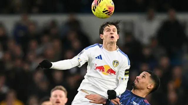 Aaronson wins a header above Saliba