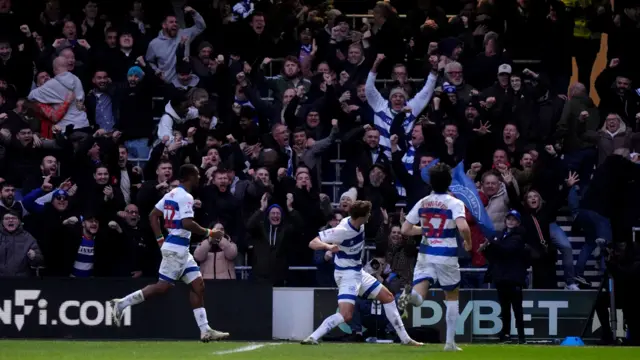 Nicolas Madsen celebrates in front of the QPR fans
