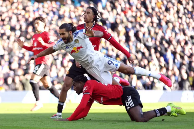 Leeds United's Dominic Calvert-Lewin in action with Manchester United's Leny Yoro and Manchester United's Ayden Heaven