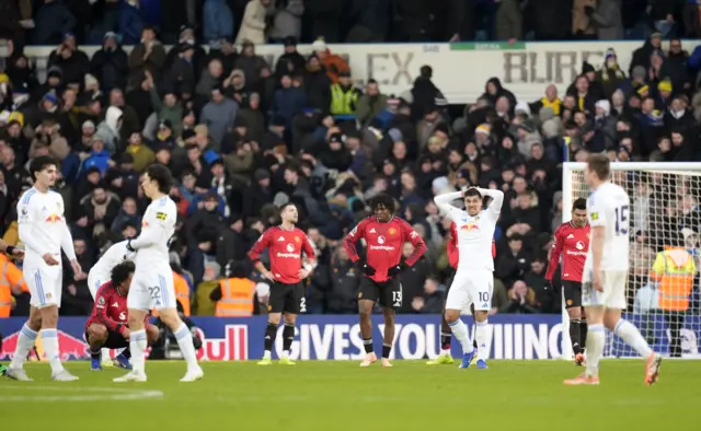 Players from both teams react at the final whistle after the Premier League match at Elland Road