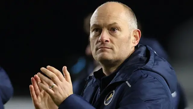Millwall boss Alex Neil applauding supporters after their win over Swansea