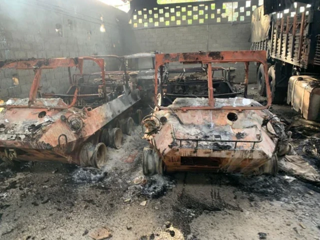 Burned vehicles and damaged structures following US airstrikes at Fuerte Tiuna