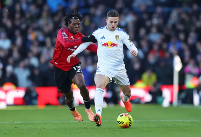 Gabriel Gudmundsson of Leeds United runs with the ball whilst under pressure from Patrick Dorgu of Manchester United
