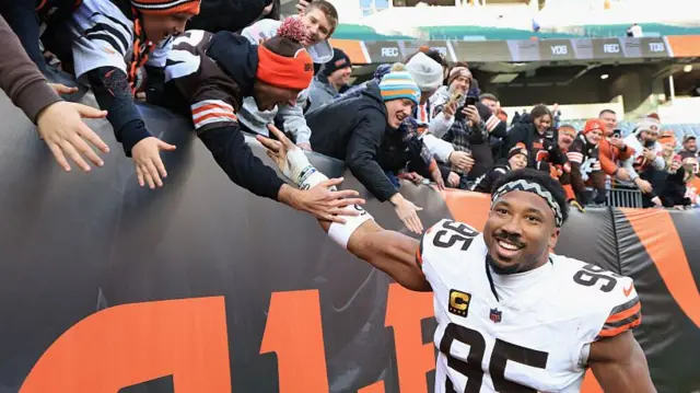 Myles Garrett celebrates with Cleveland Browns fans after setting the NFL sack record