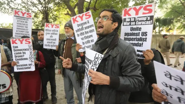 Supporters of Indian left parties hold placards during a protest against US military actions in Venezuela, in New Delhi