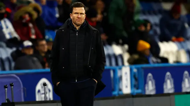 Exeter manager Gary Caldwell stands on the touchline