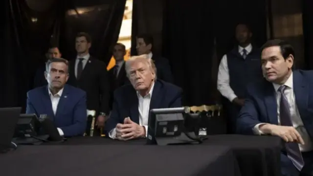 Three men dressed in shirts and blazers watching into distance