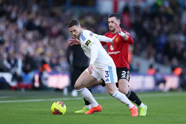 Gabriel Gudmundsson of Leeds United is challenged by Diogo Dalot of Manchester United