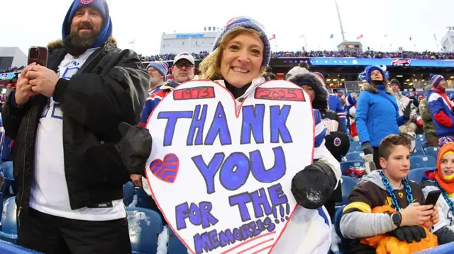 A Buffalo Bills fan holding a sign during the team's final game at Highmark Stadium